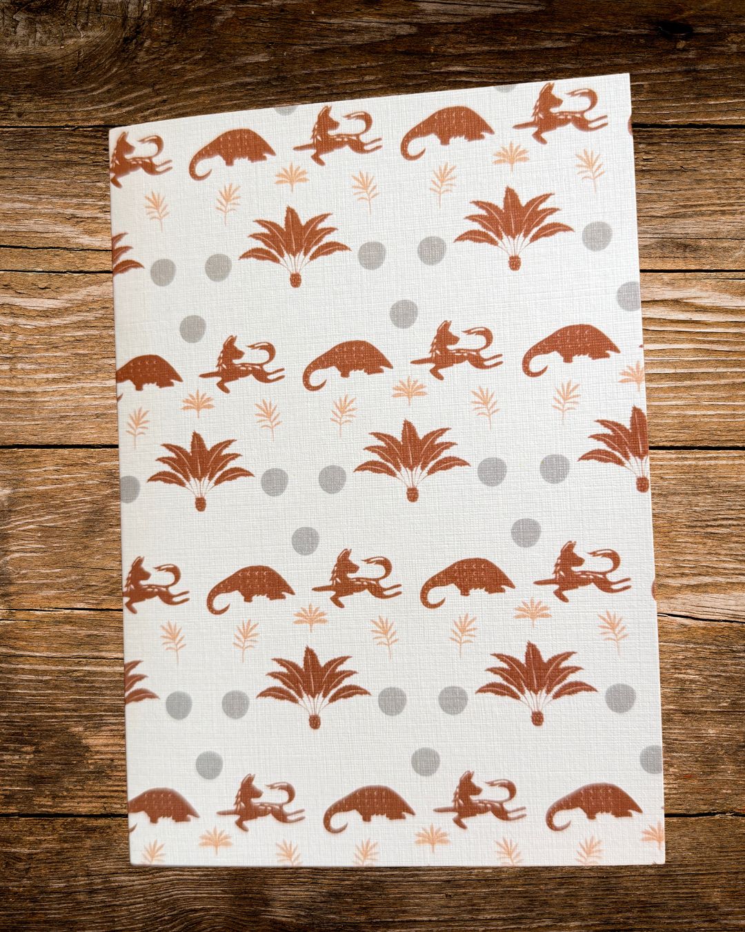 dot and trail card, terracotta pangolins, wild dogs and cycads with grey dots