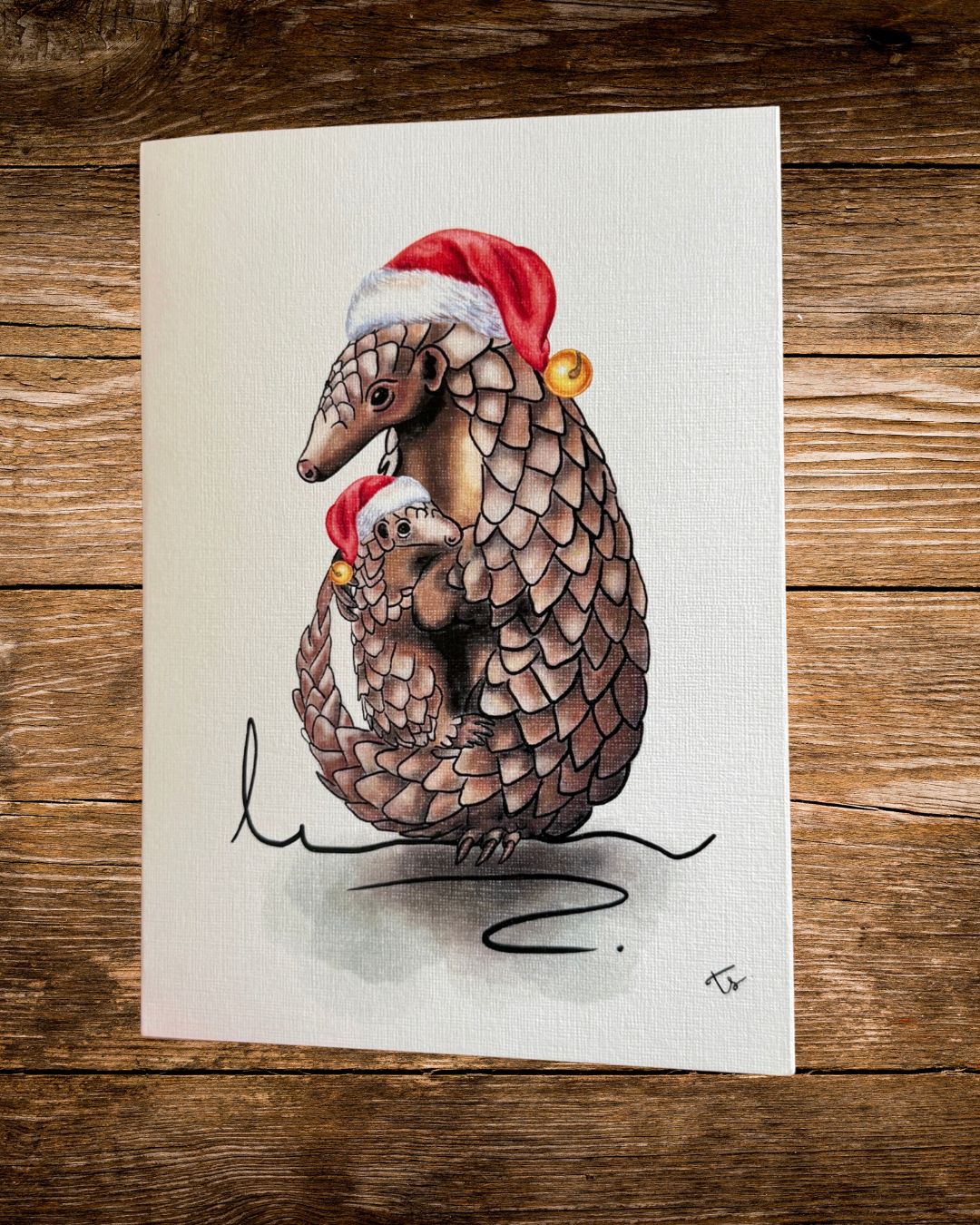pangolin hats christmas card, a pangolin and baby in christmas hats