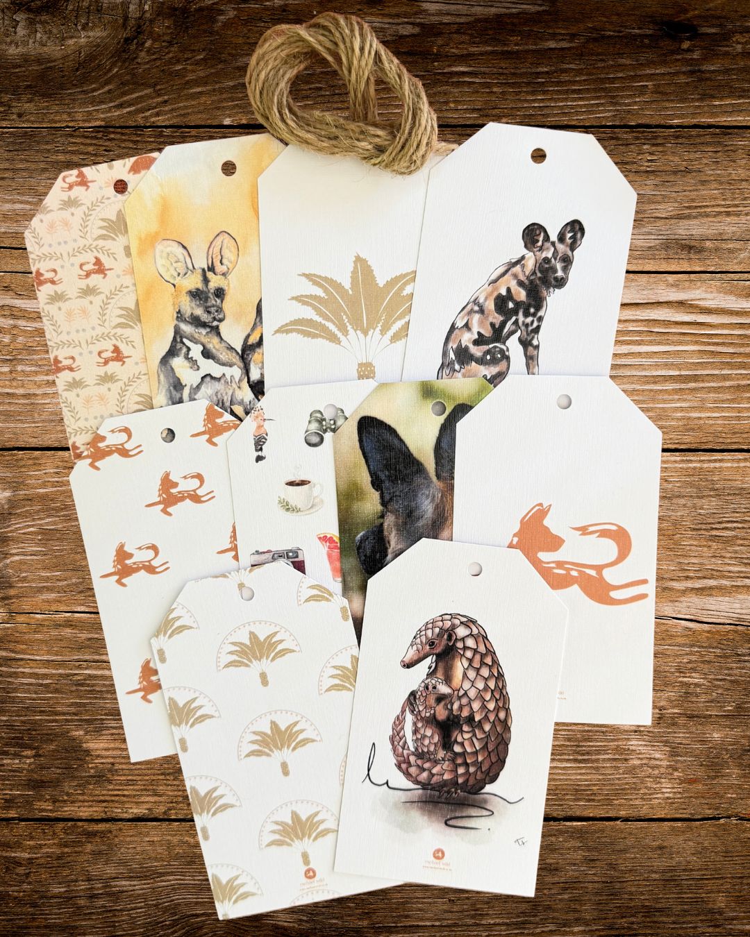 pack of ten african wildlife gift tags fanned out on a wooden table