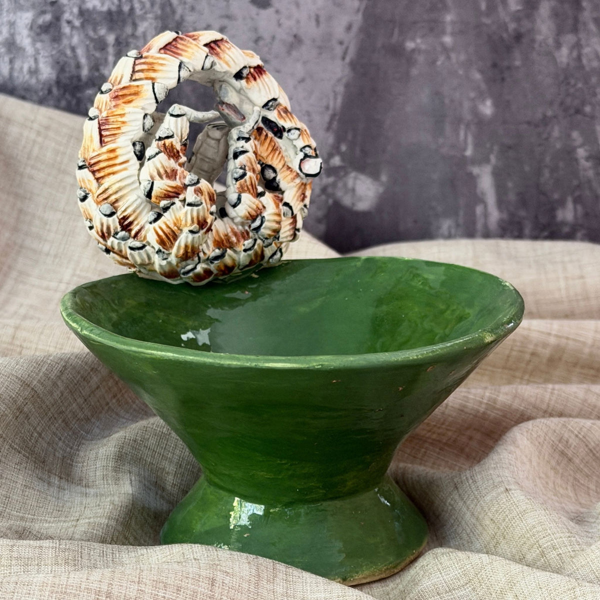 forest green ceramic mini raised bowl with a hand sculpted pangolin curled into a ball on the rim