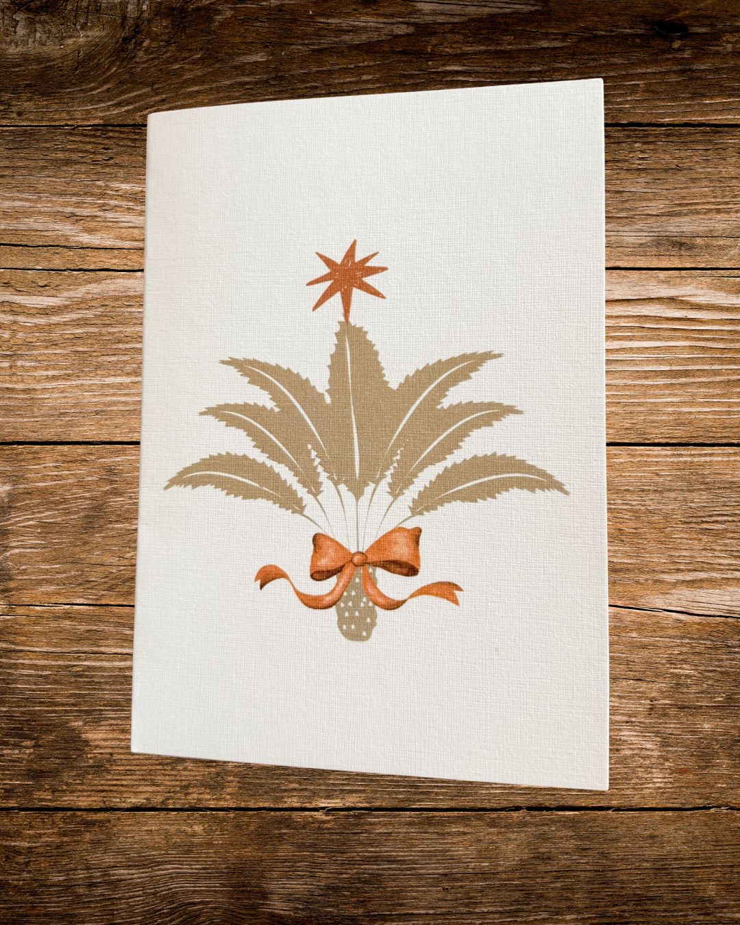 cycad christmas tree card with a star and a bow