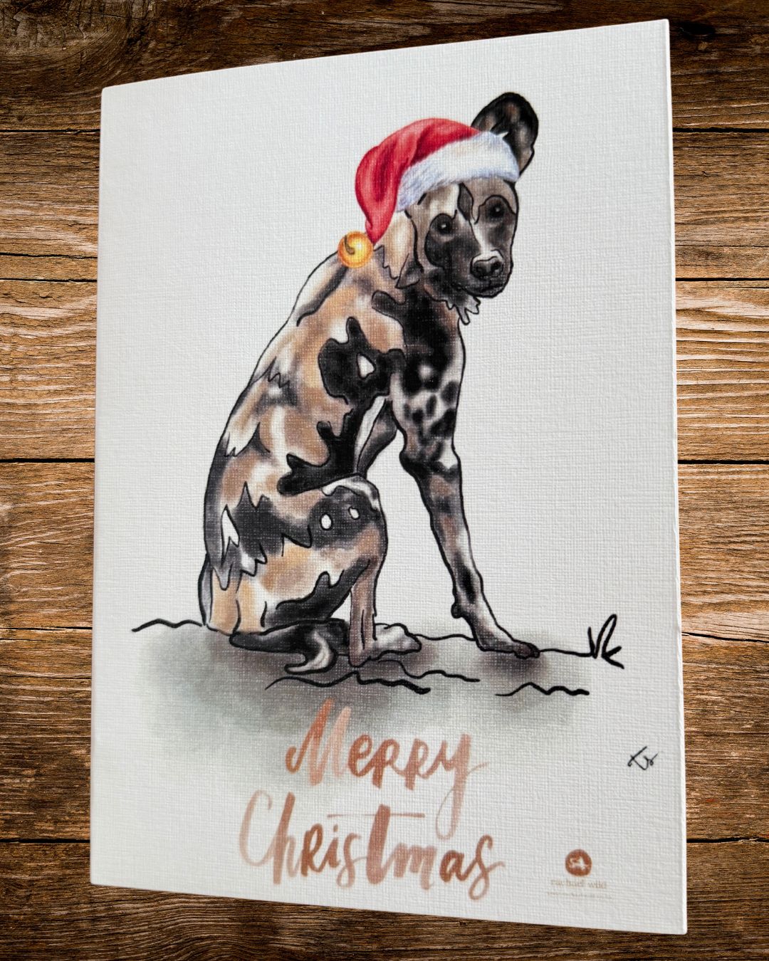 wild dog hat christmas card, an african wild dog in a red christmas hat