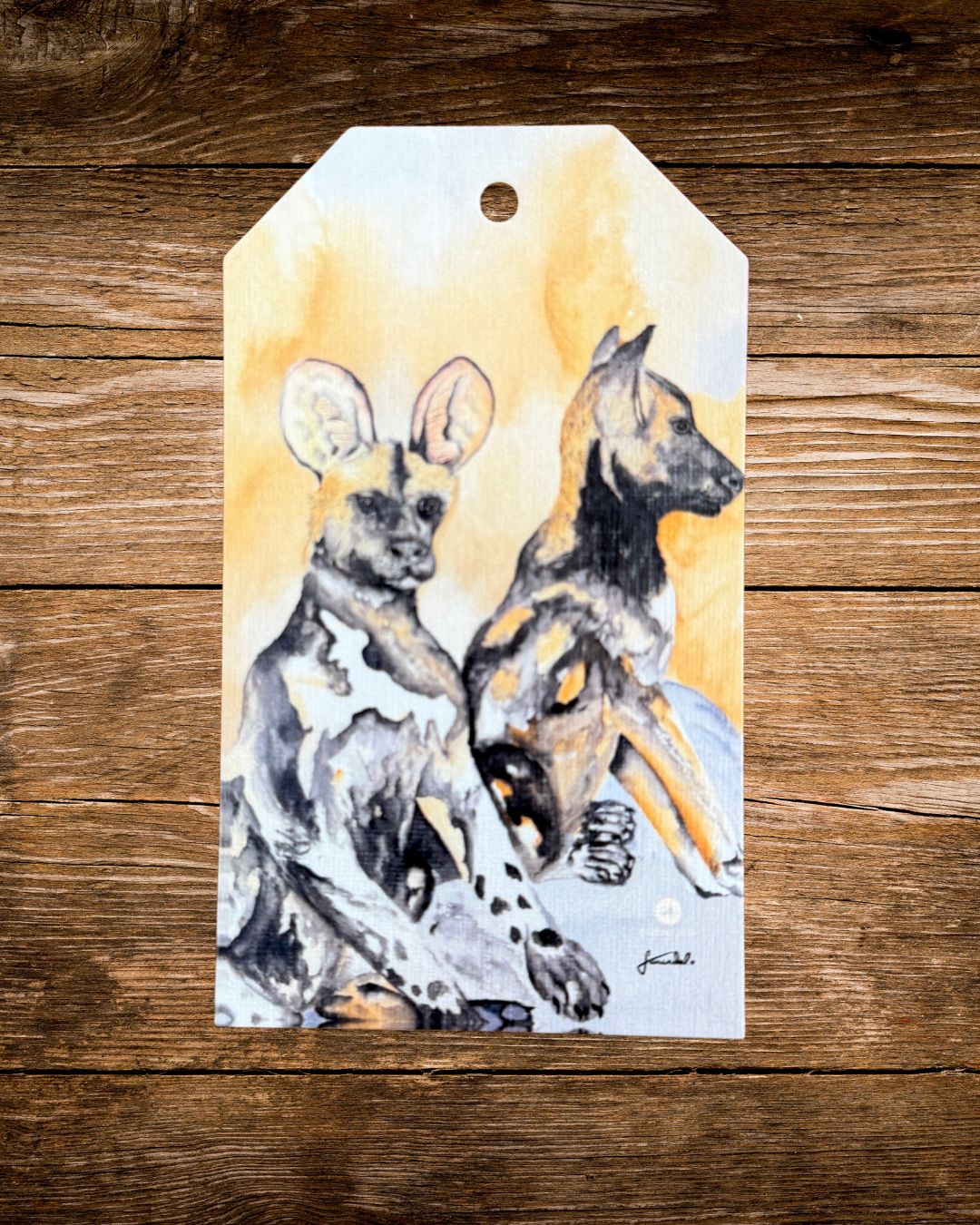 wild dog watercolour gift tag, two painted african wild dogs on a golden background