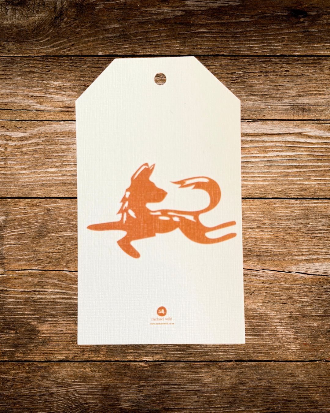 wild procession gift tag, a painted terracotta african wild dog by rachael wild