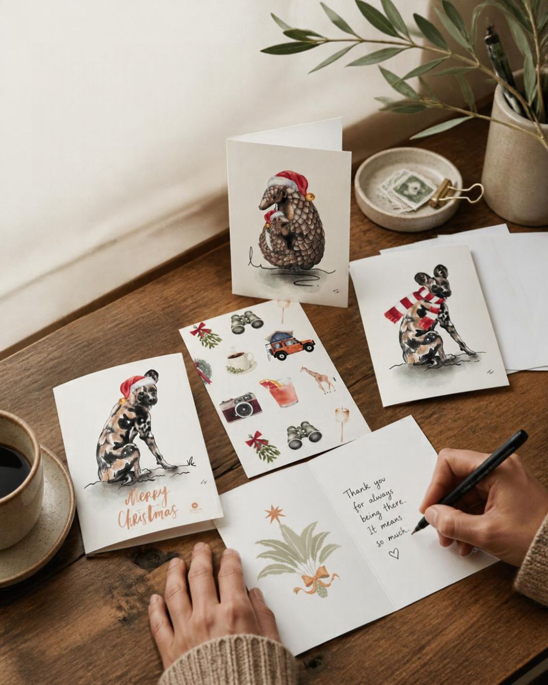 writing a rachael wild christmas card at a desk